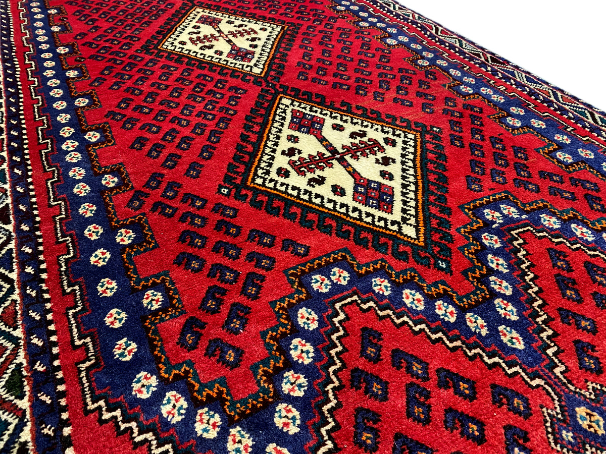 Red runner rug with squares, zigzag, and ornamental patterns