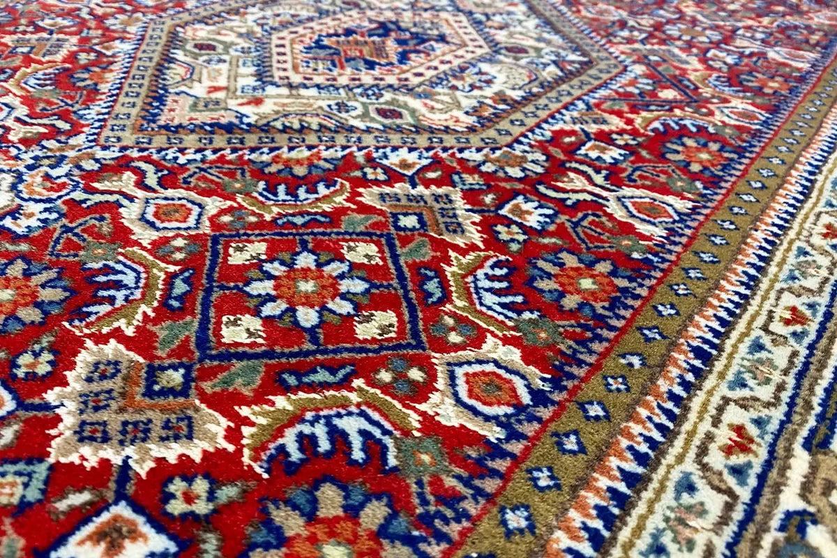 Bidjar runner with red center, blue border band, and medallion patterns, detail view