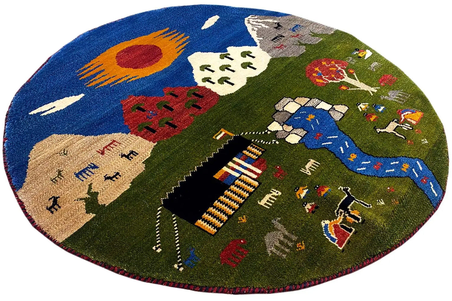 Round Gabbeh rug (101×101 cm) with a blue river, figures, and trees