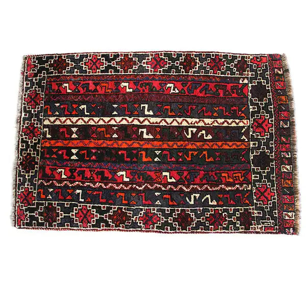Rectangular rug with a geometric striped pattern, dark red, black, blue, and cream