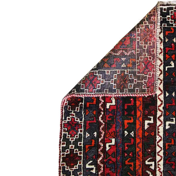 Close-up of a carpet edge: integrated patterned sections in dark red, black, and cream