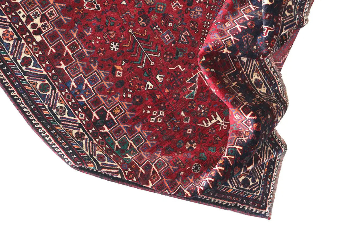 Carpet edge with an ornamental border in blue, red, and beige, slightly folded