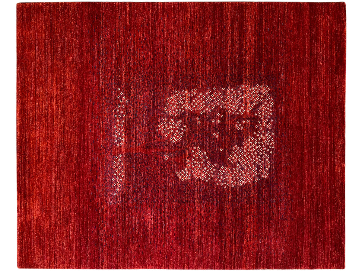 Red carpet with a medium ornamental medallion and fine, dark pile pattern