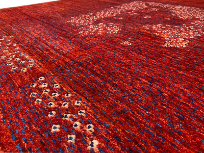 Red carpet detail with border arrangement and medallion pattern in a pointillist design