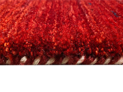 Red carpet close-up of the edge with dense pile and visible hem