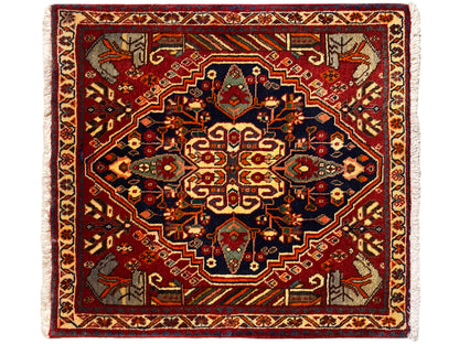 Carpet 65x59 cm with a red background, blue-gray ornaments, and a symmetrical pattern