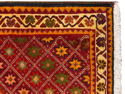 Poshti rug close-up: colorful ornamental border and dense pattern in the inner field.