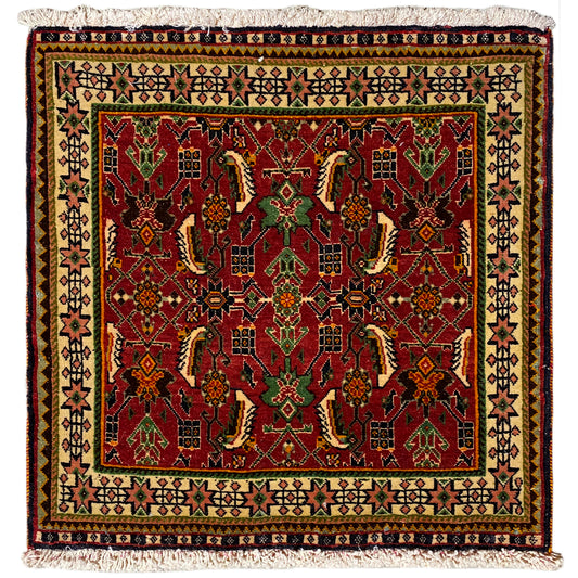 Poshti rug 63x61 cm with a red and green pattern, with fringes along the edge.