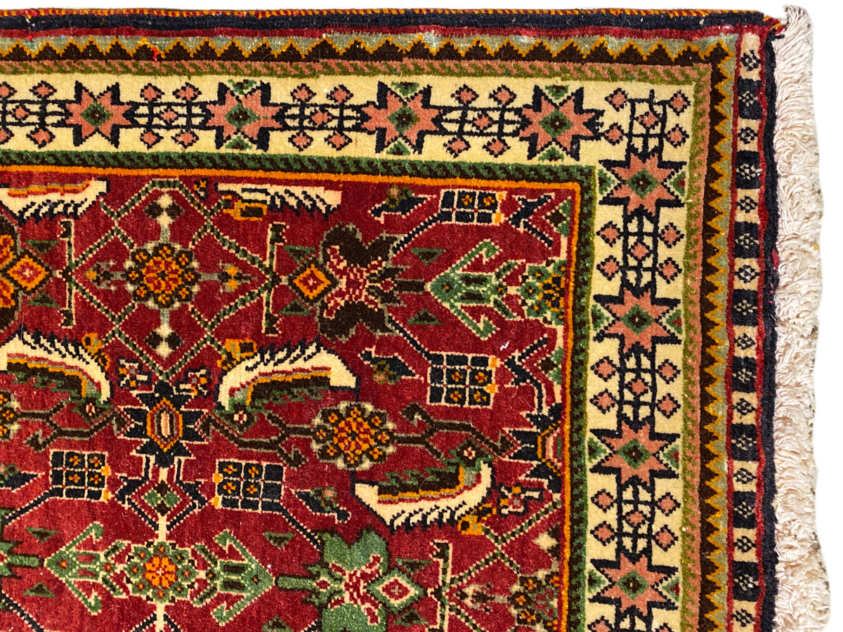 Poshti rug 63x61 cm detail view: red ornamental field with green and yellow motifs.
