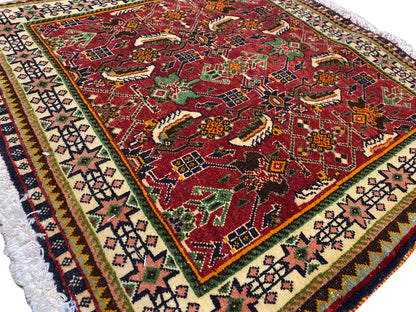 Poshti rug 63x61 cm close-up: red pattern with animal/ornamental motifs and border.