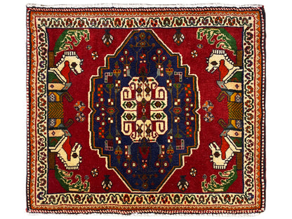 Poshti rug with a red ground, blue central medallion, and decorative border