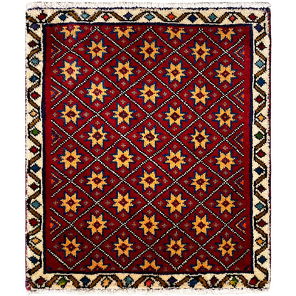 Square rug with a red background and a multicolored geometric star pattern